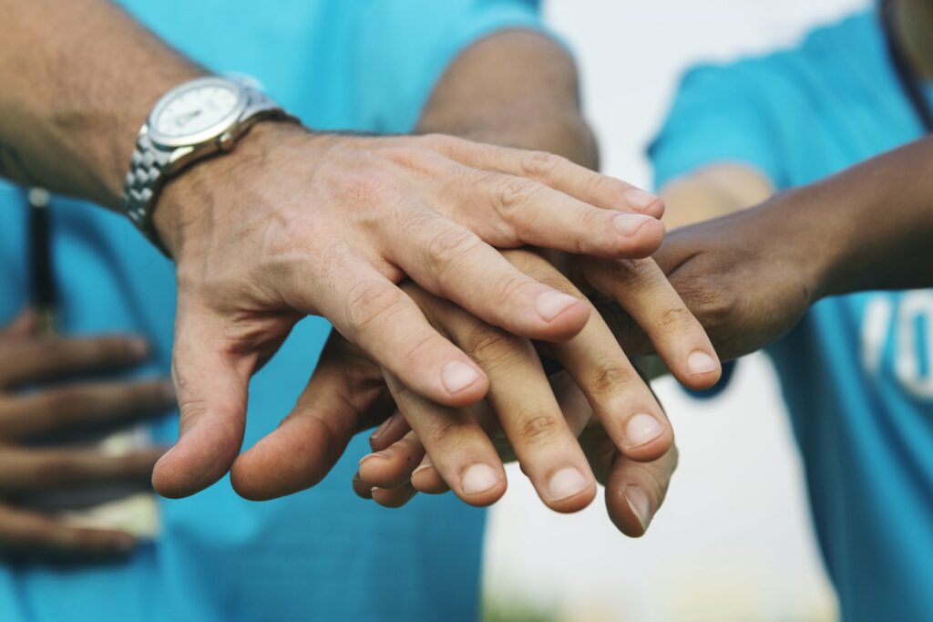 Team of volunteers stacking hands